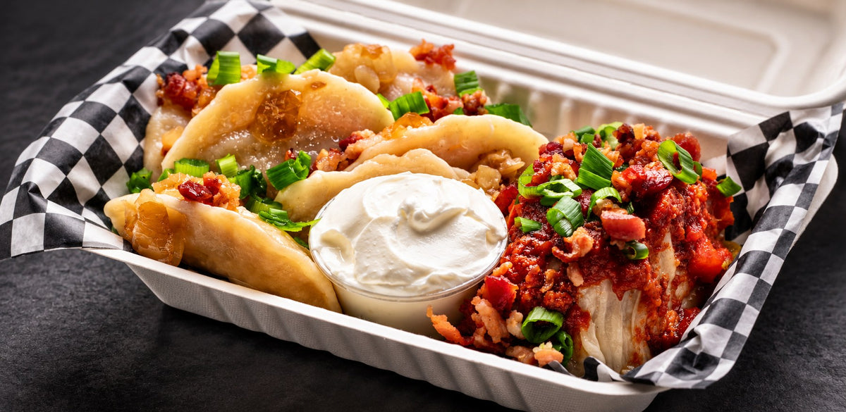 Pierogies and a cabbage roll with sour cream